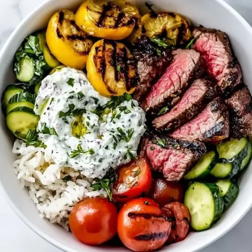 Grilled Mediterranean Steak Bowl with fresh vegetables and herbs.