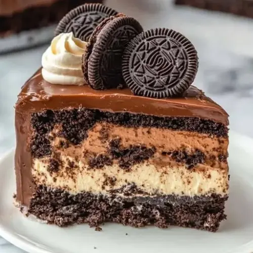 Delicious Oreo Cheesecake of Dreams topped with crushed Oreos and chocolate drizzle