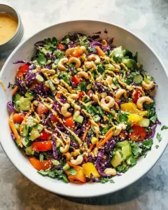 Rainbow Veggie Salad with toasted cashews, colorful vegetables in a bowl