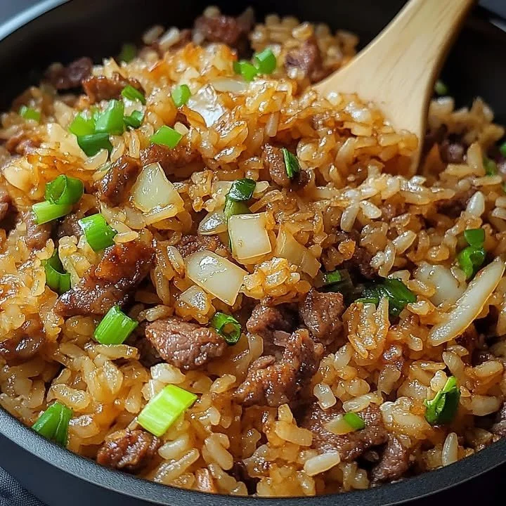 Delicious savory onion beef fried rice served in a bowl.
