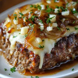 Delicious slow cooker French onion beefloaf served with melted cheese.