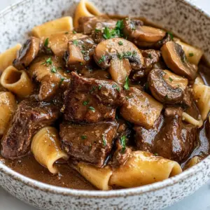 Crockpot beef tips served with noodles in a rich sauce